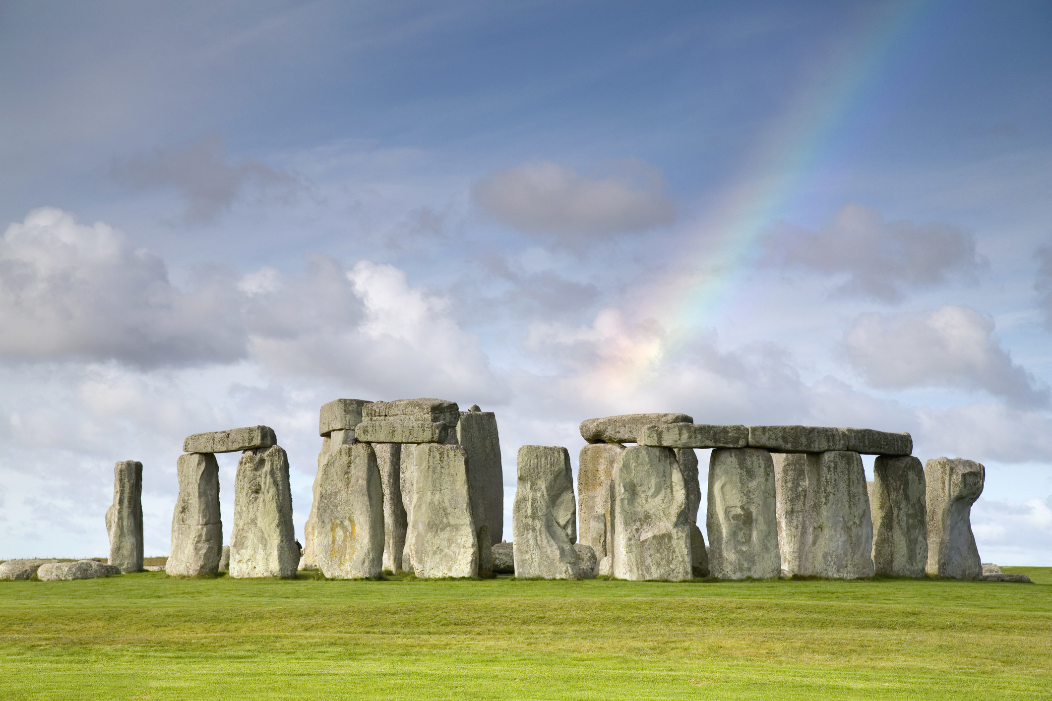 stonehenge rocks with a rainbow in the sky