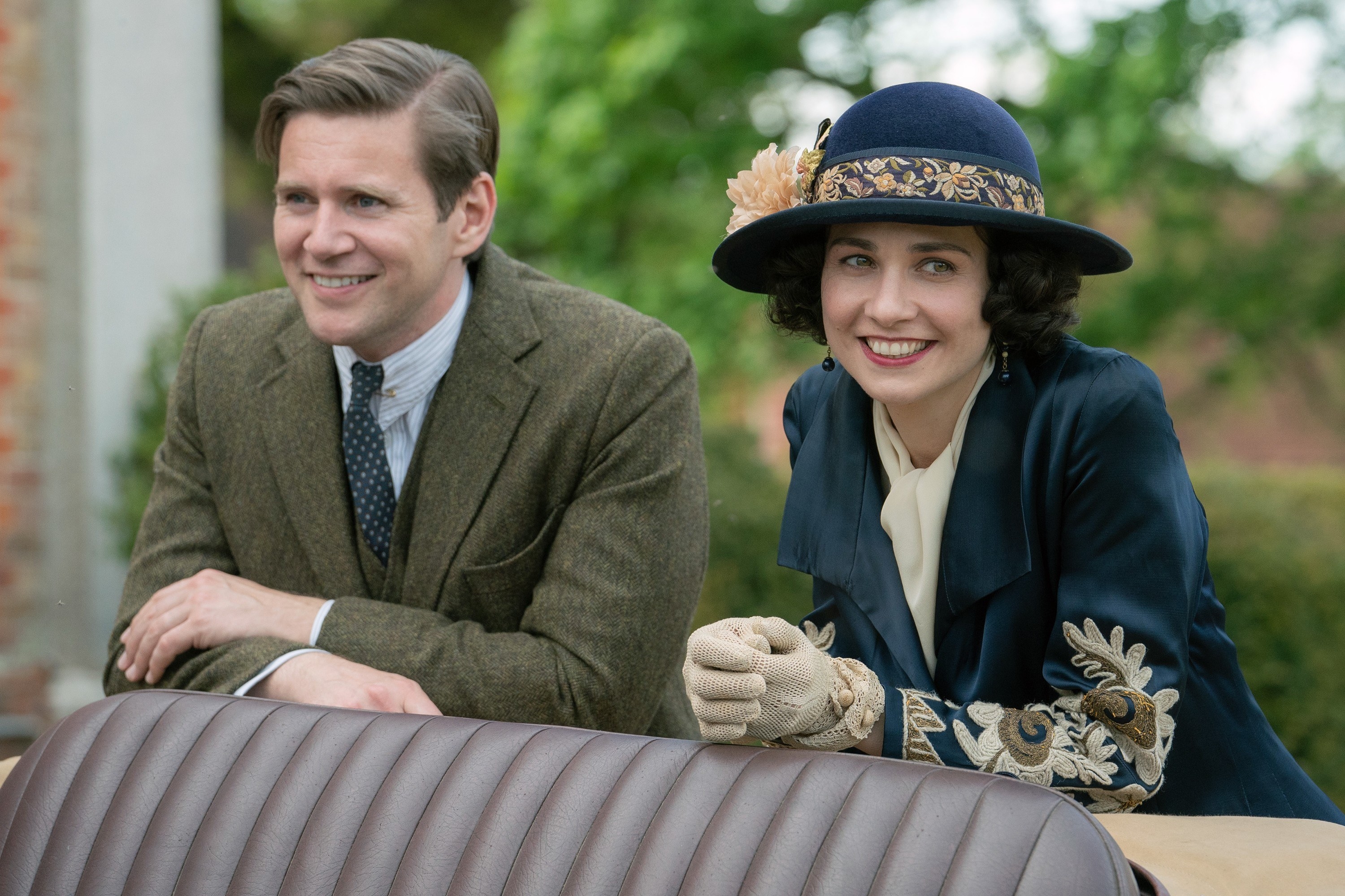 Allen Leech and Tuppence Middleton smiling.