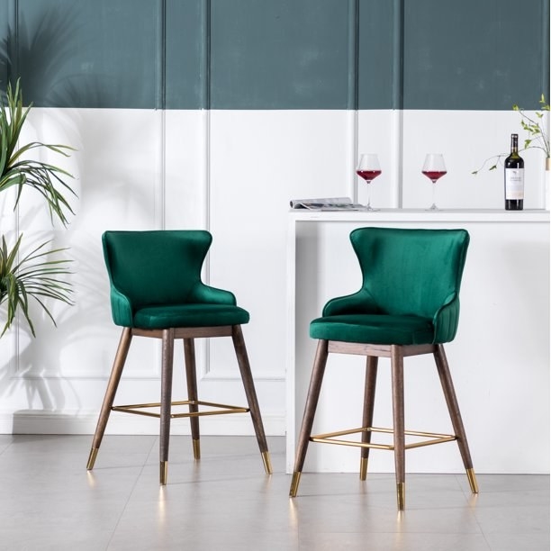 two velvet green counter stools