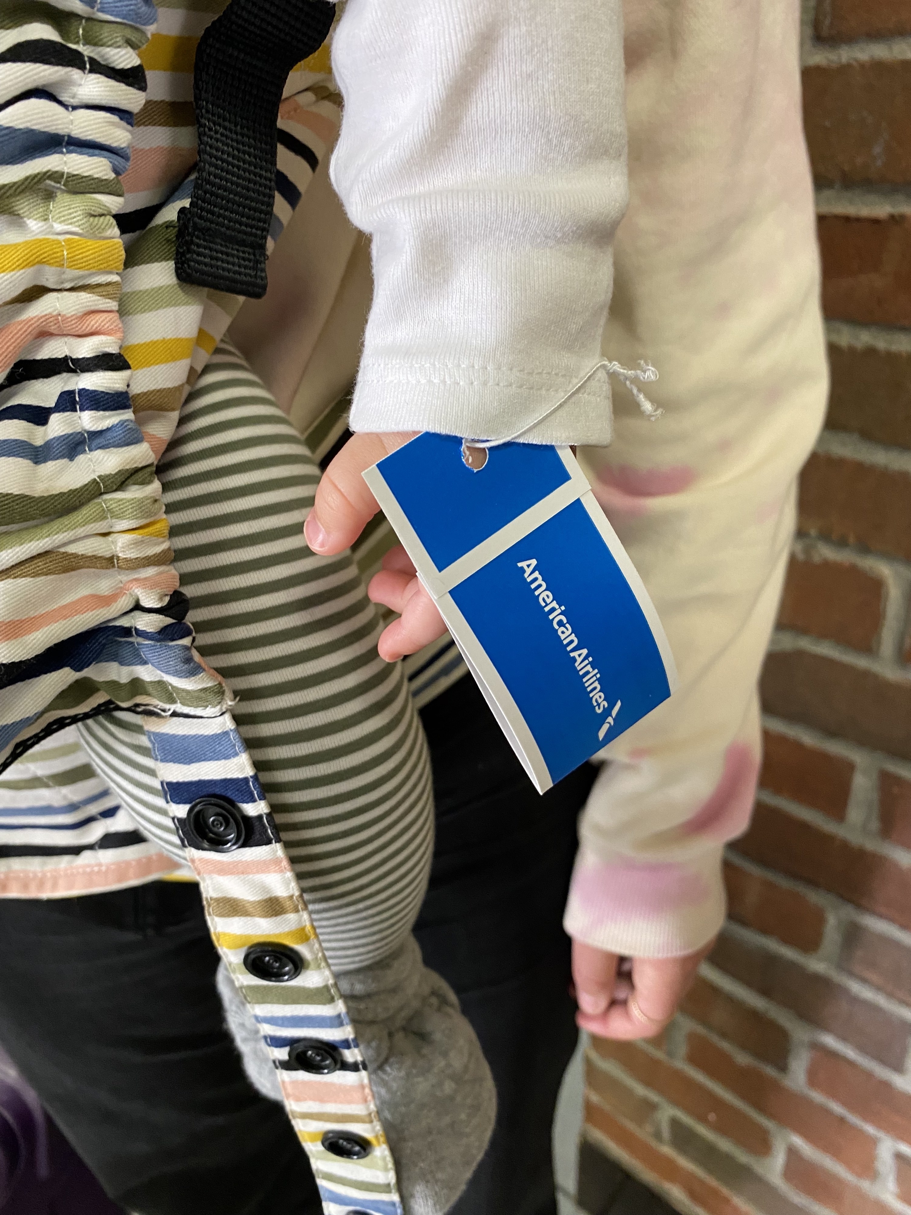 Baby in a carrier with a tag attached to them