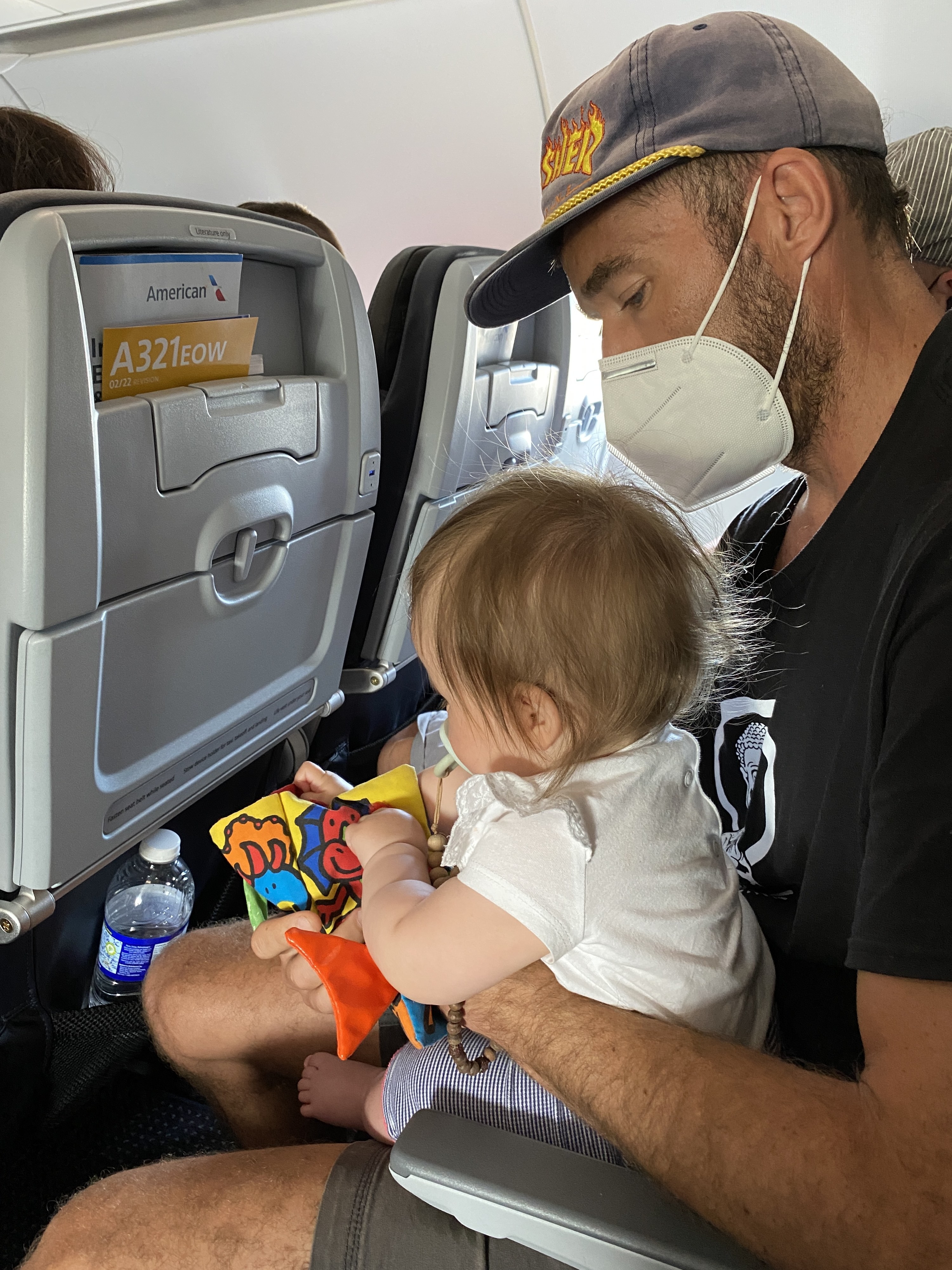 Man with baby who is playing with a toy