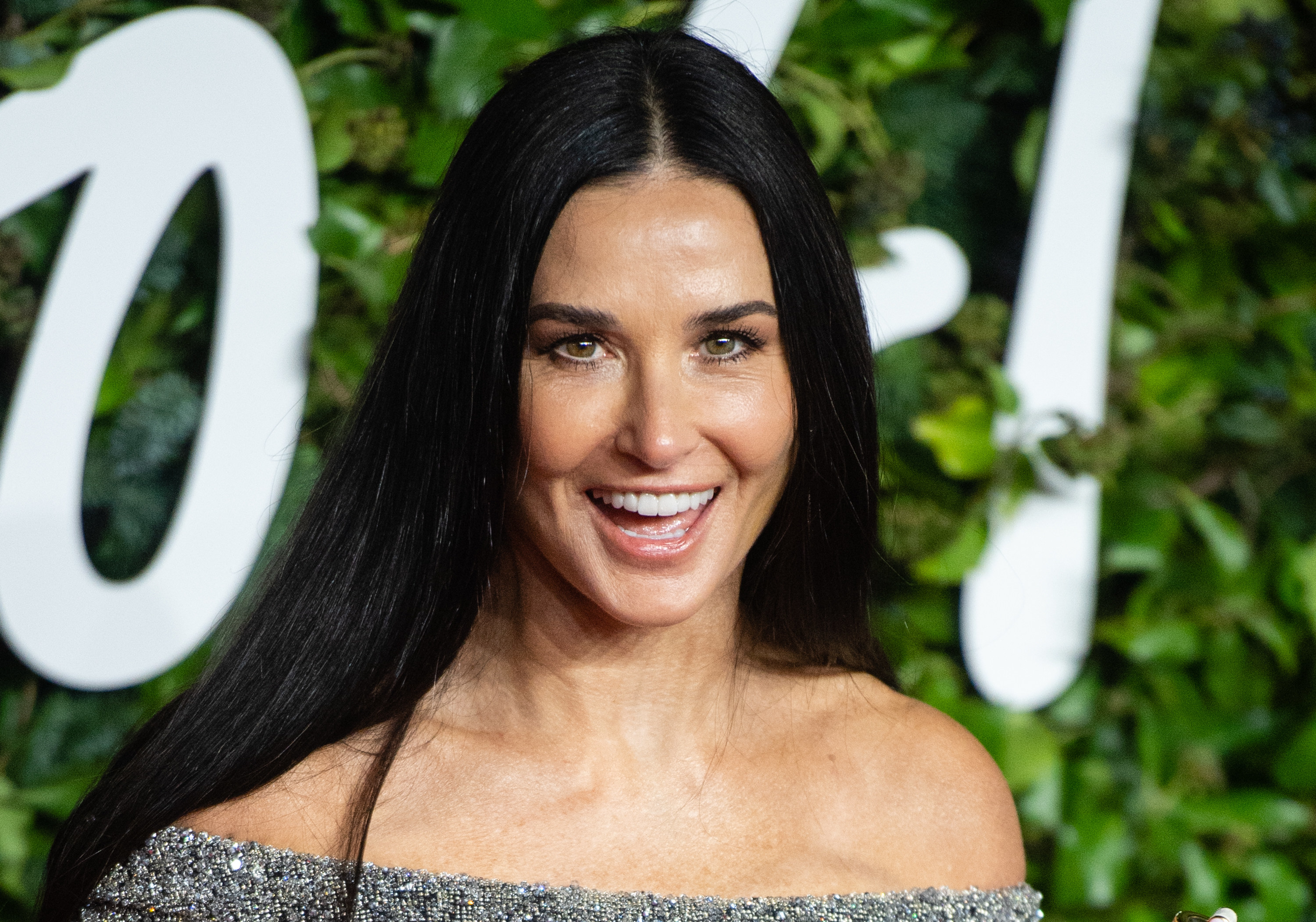 Demi Moore smiling for the camera at an event