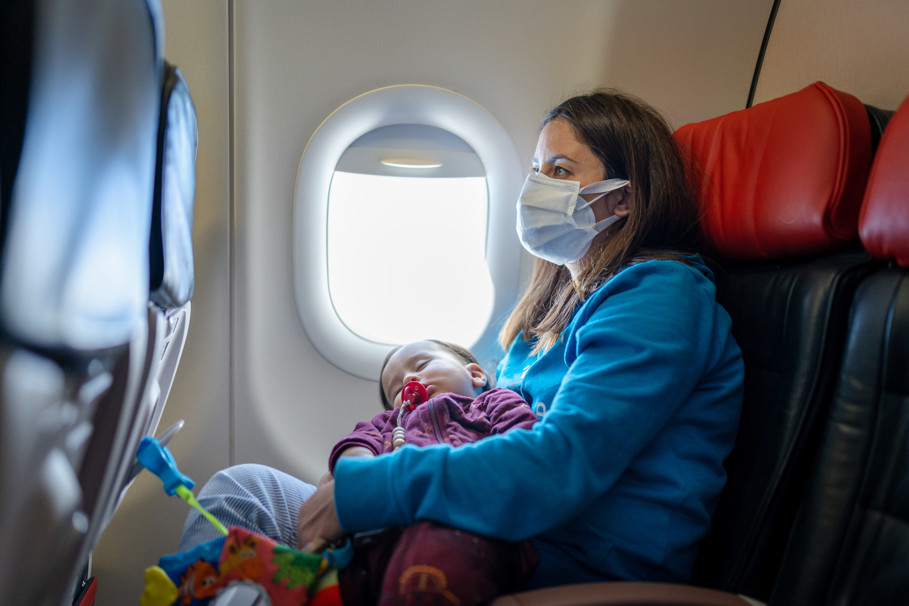 Woman holding a baby on an airplane