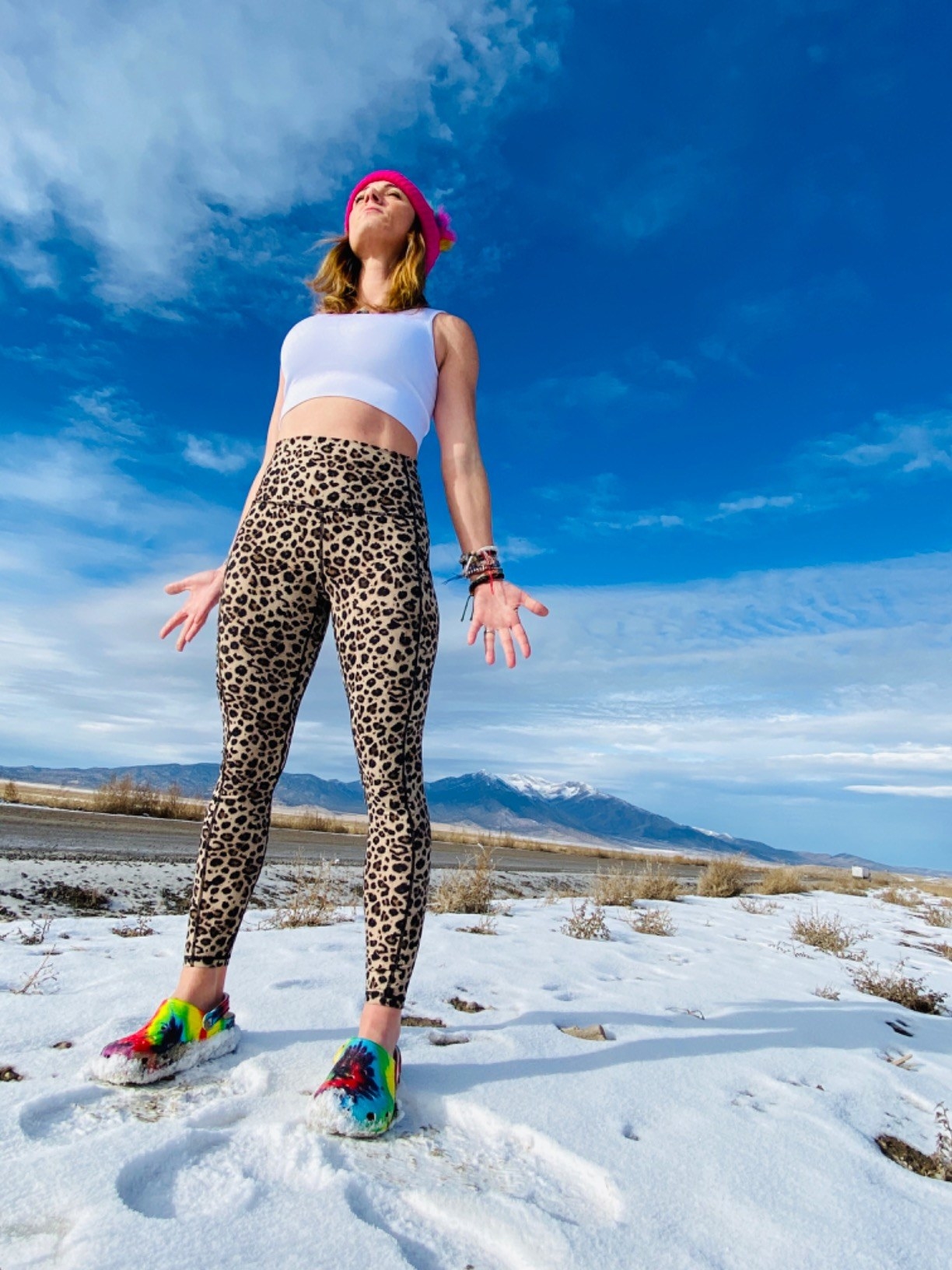 a reviewer wearing the black leggings on top of a mountain