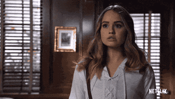 A GIF of Debby Ryan as Patty Bladell walking while sighing nervously