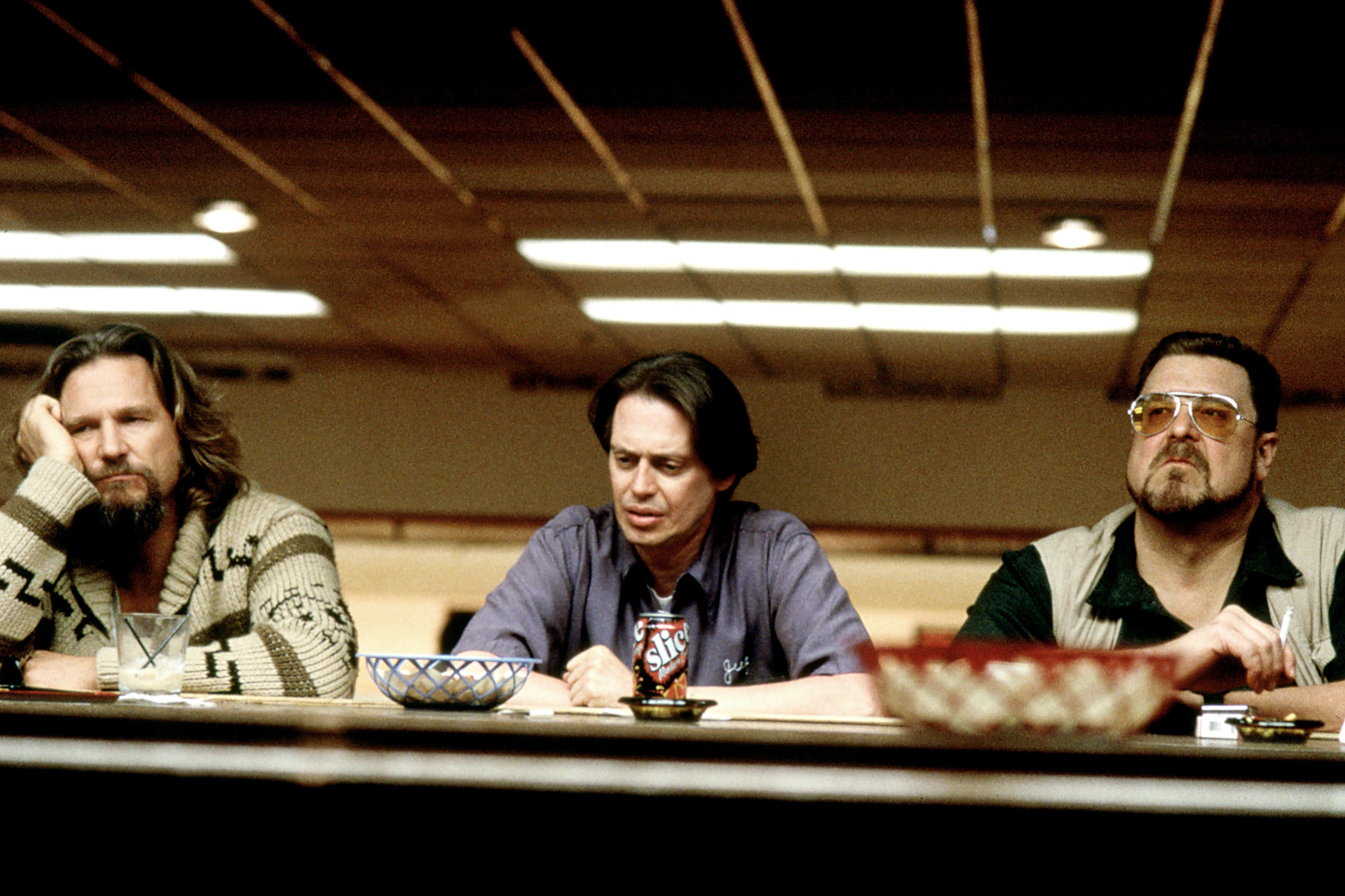 Jeff Bridges, Steve Buscemi, and John Goodman sitting at a bar