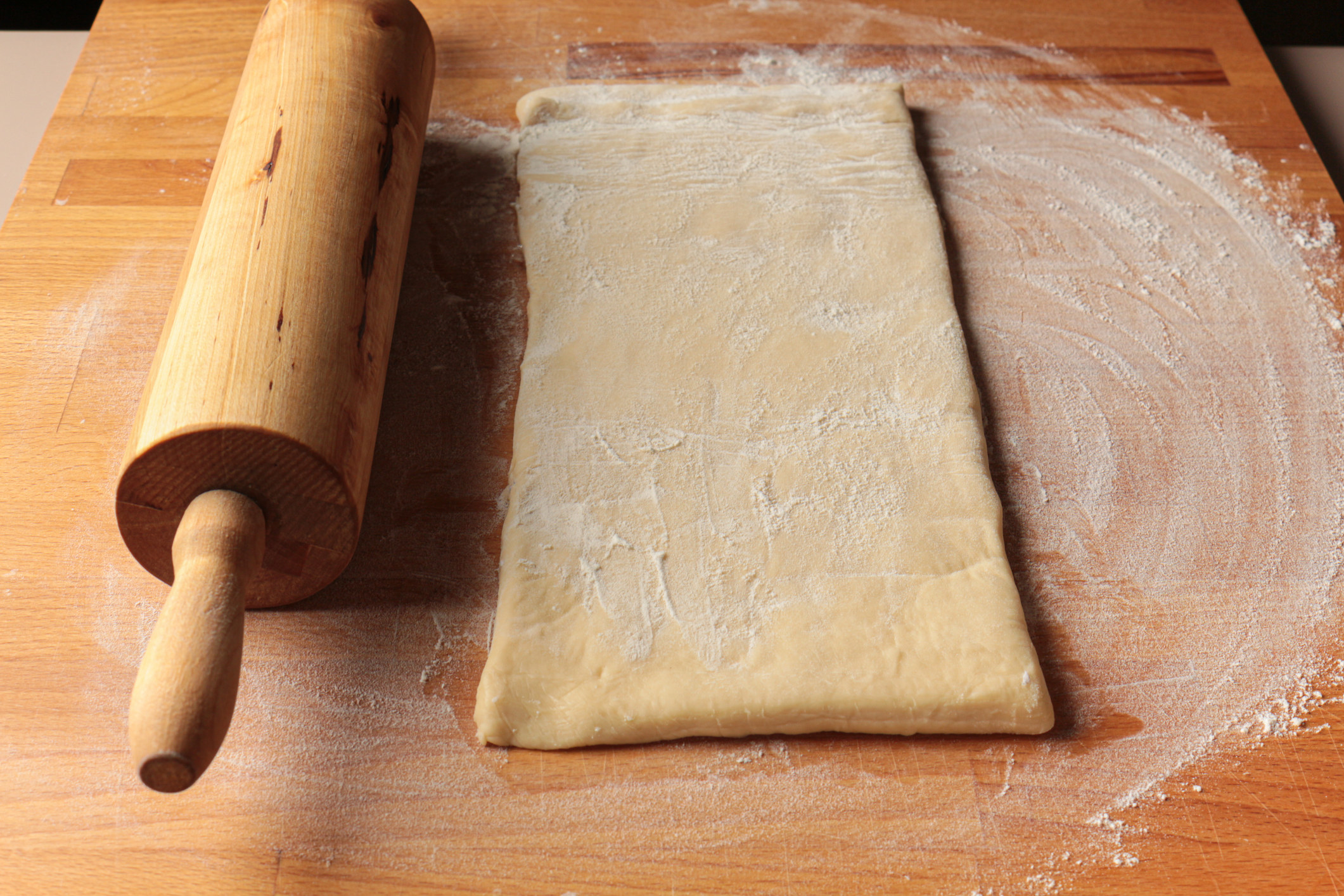 Rolling out a piece of puff pastry.