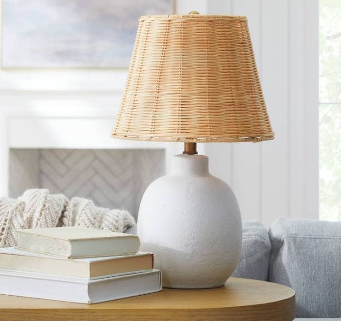Rattan table lamp with white base on living room side table