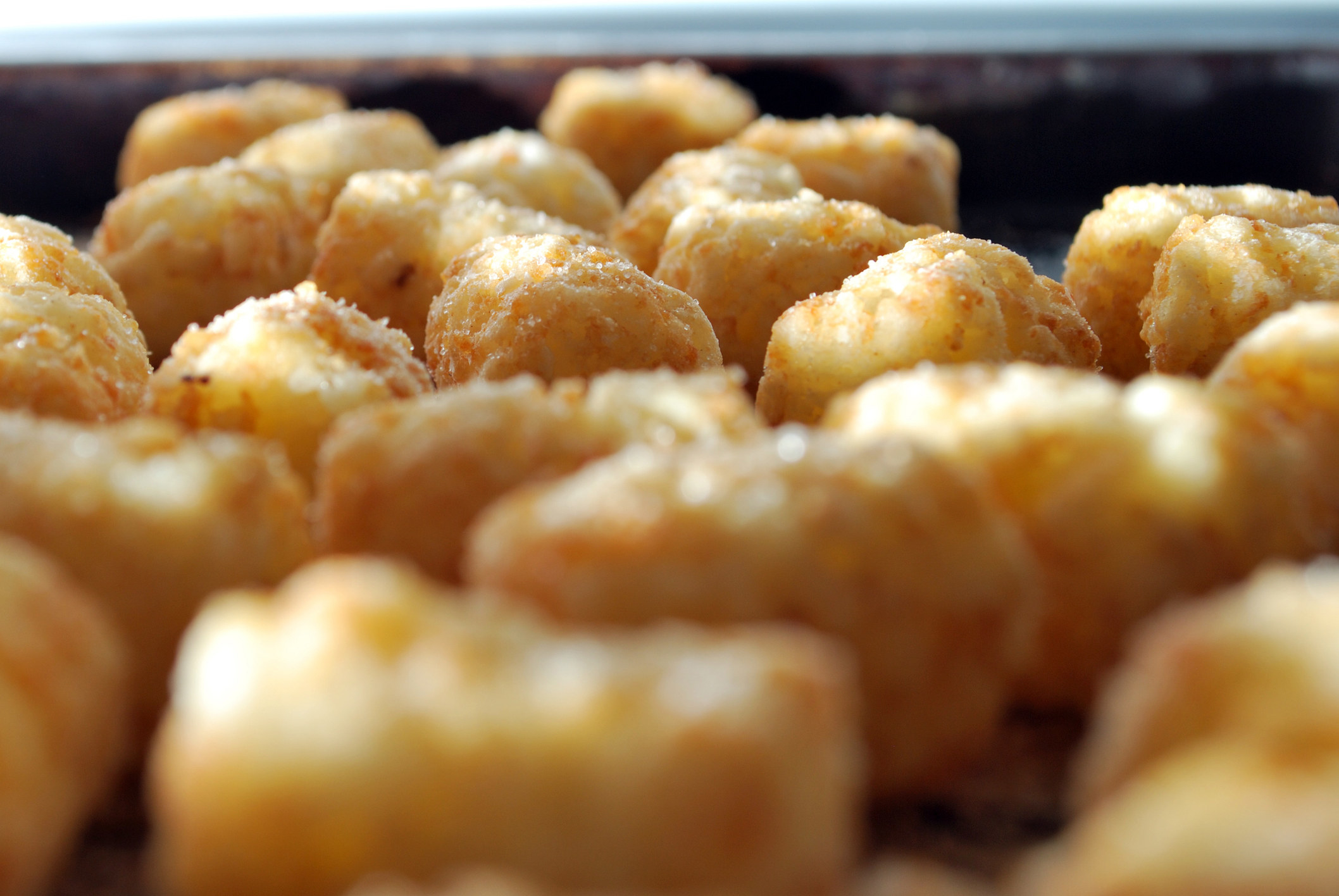 A close up of cooked tater tots.