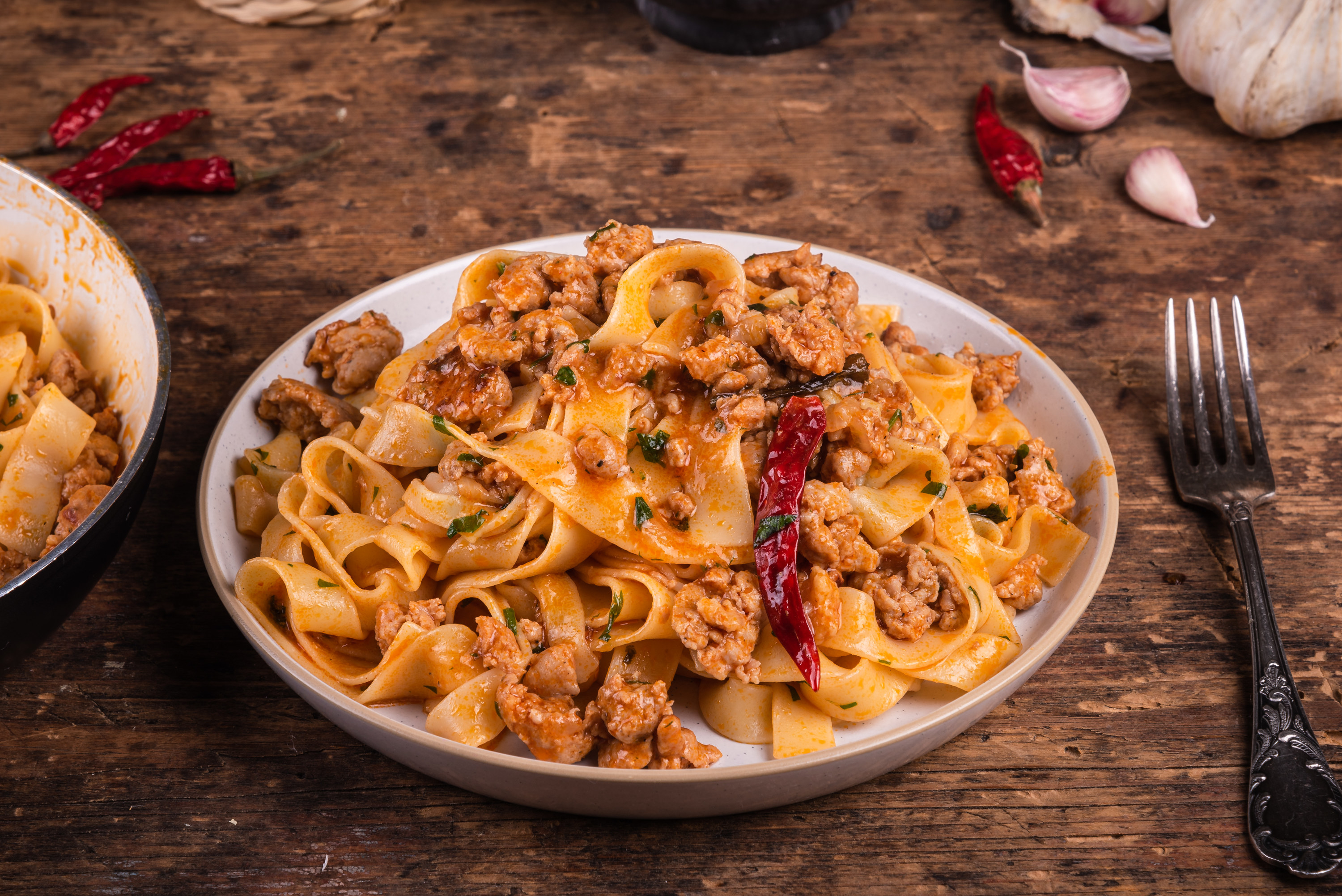 a pasta dish on a table next to a fork