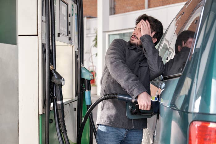 stressed man refilling his gas tank