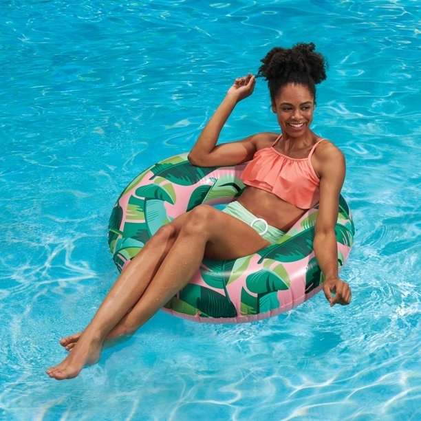 Person sitting in the float in a pool