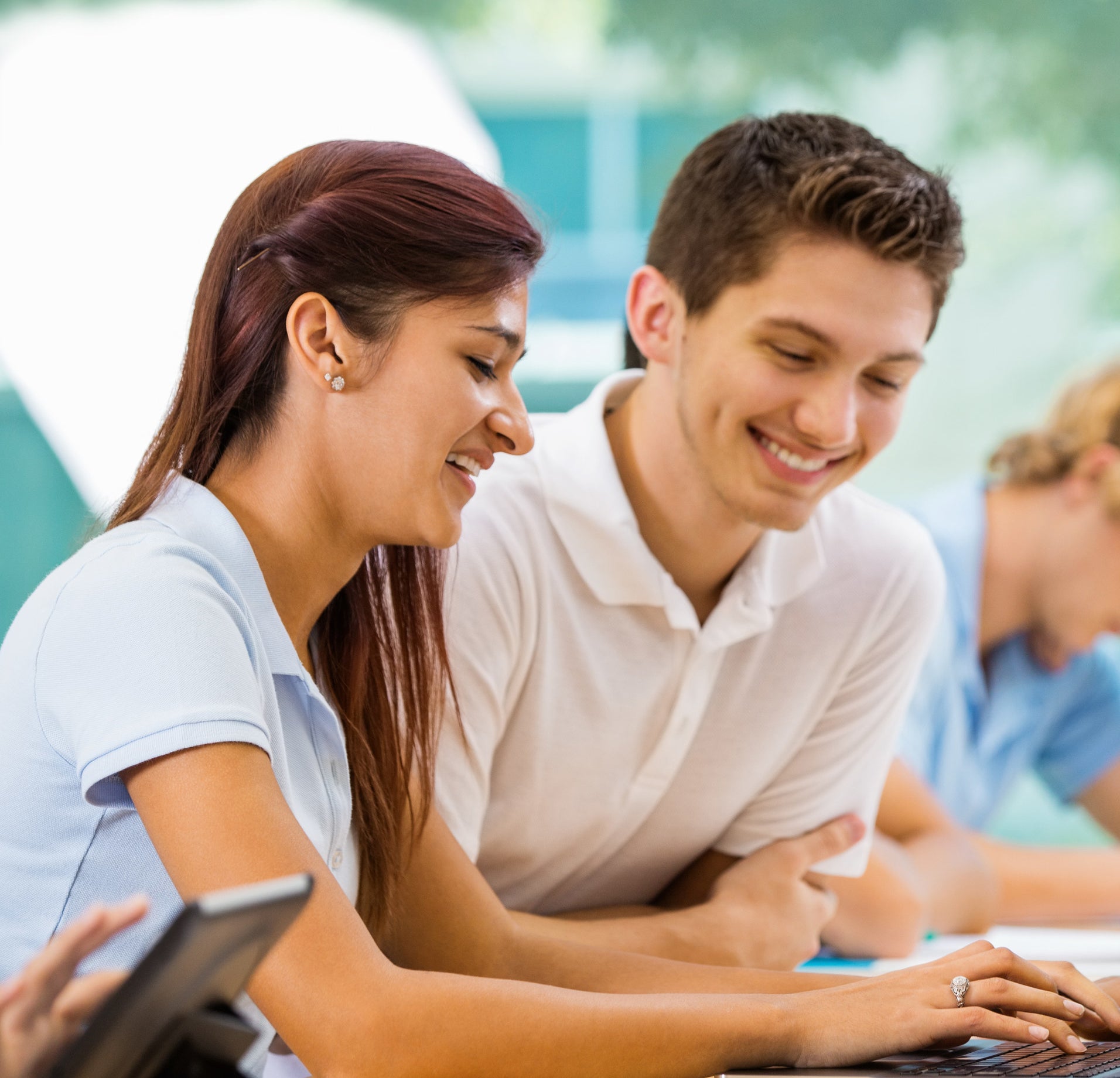 Two students laugh together during class