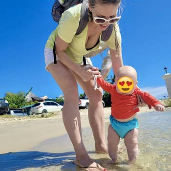 reviewer's photo of with baby wearing the reusable swim diaper