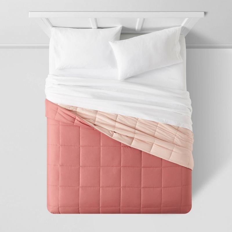 The comforter in ppink/blush on a bed