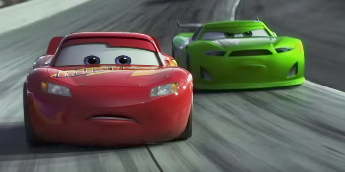 lightening mqueen looking concerned on the race track while an angry green car is behind him