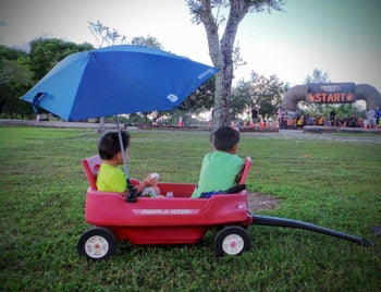 reviewer's photo of a blue umbrella attached to a wagon
