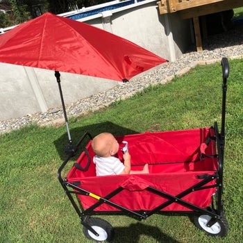 reviewer's photo of a red umbrella attached to a wagon