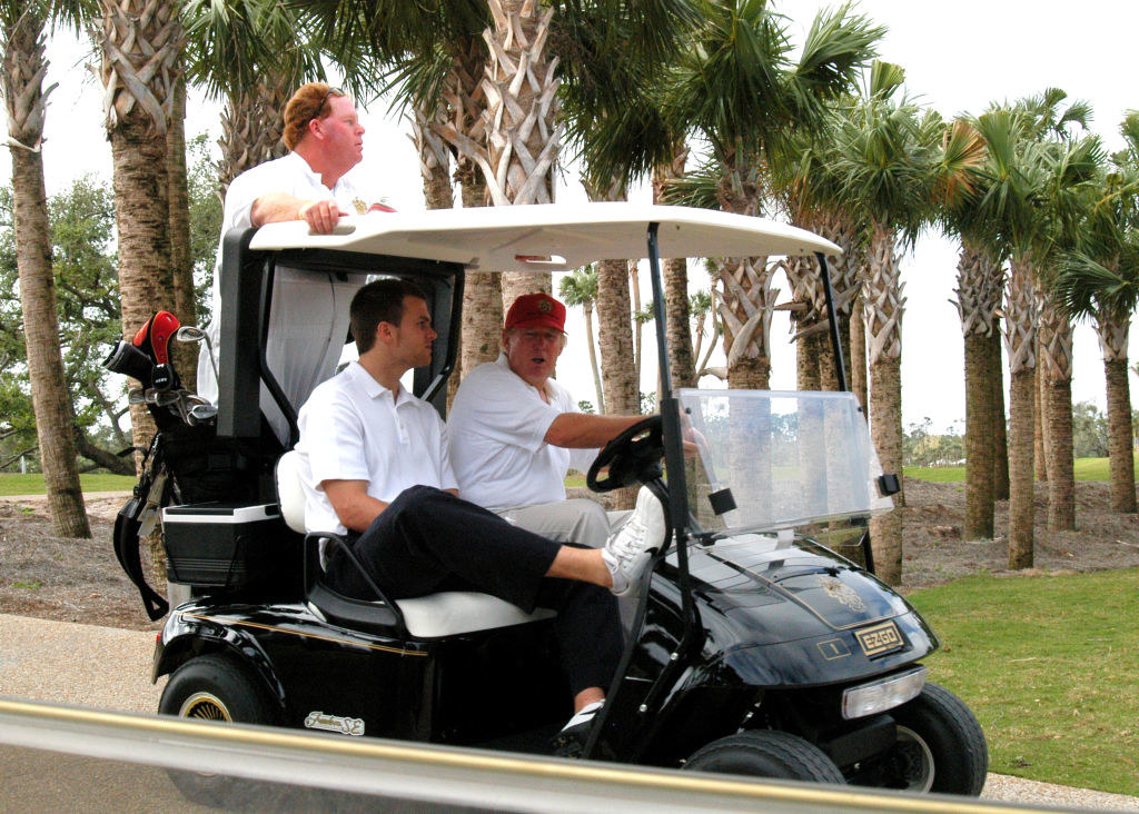 trump and brady in a golf cart