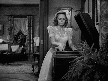 Donna Reed in a dress breaking a vinyl