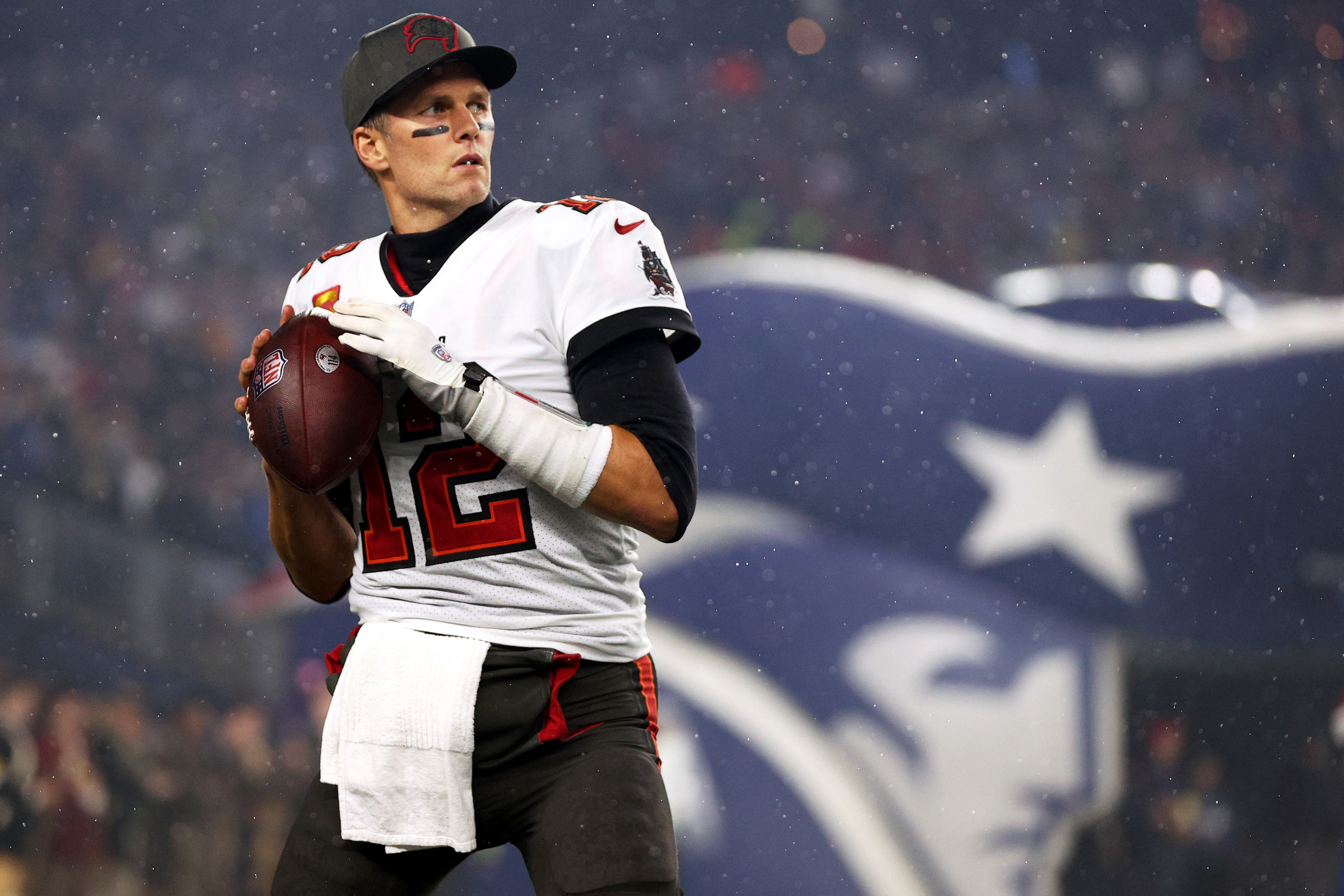 tom on the field holding a football