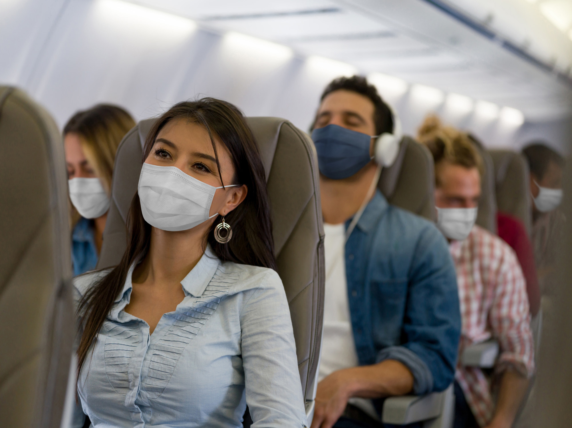 flyers in the plane wearing masks