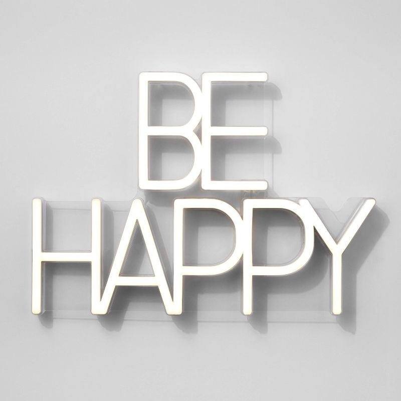 the sign in be happy on a wall