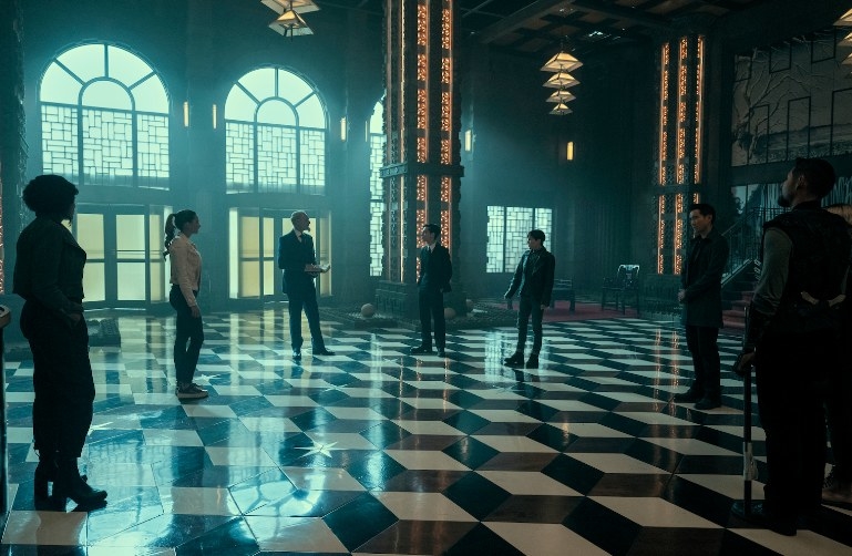 The Umbrella Academy characters sand in a circle in the foyer of the Hotel Oblivion