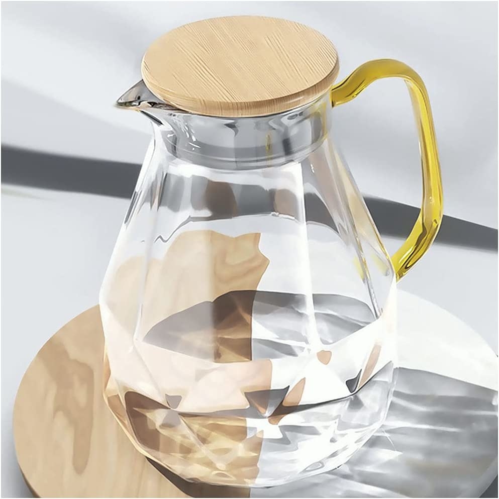a glass jug with a bamboo lid