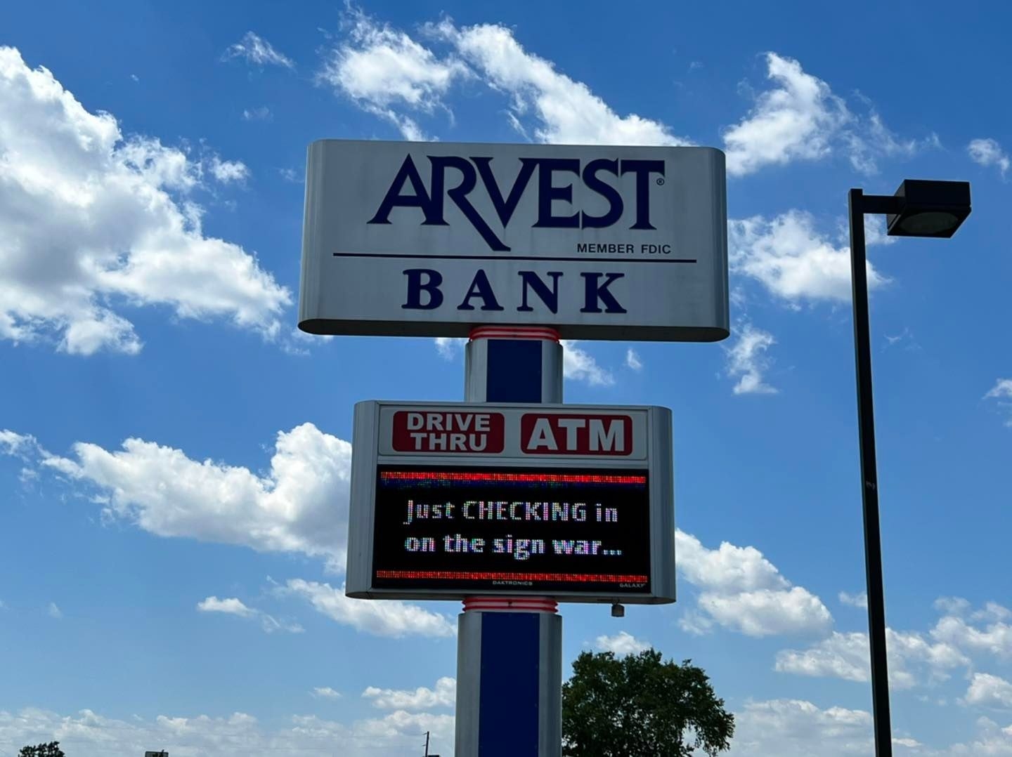 Arvest Bank&#x27;s sign reads &quot;Just checking in on the sign war&quot; with checking in all caps