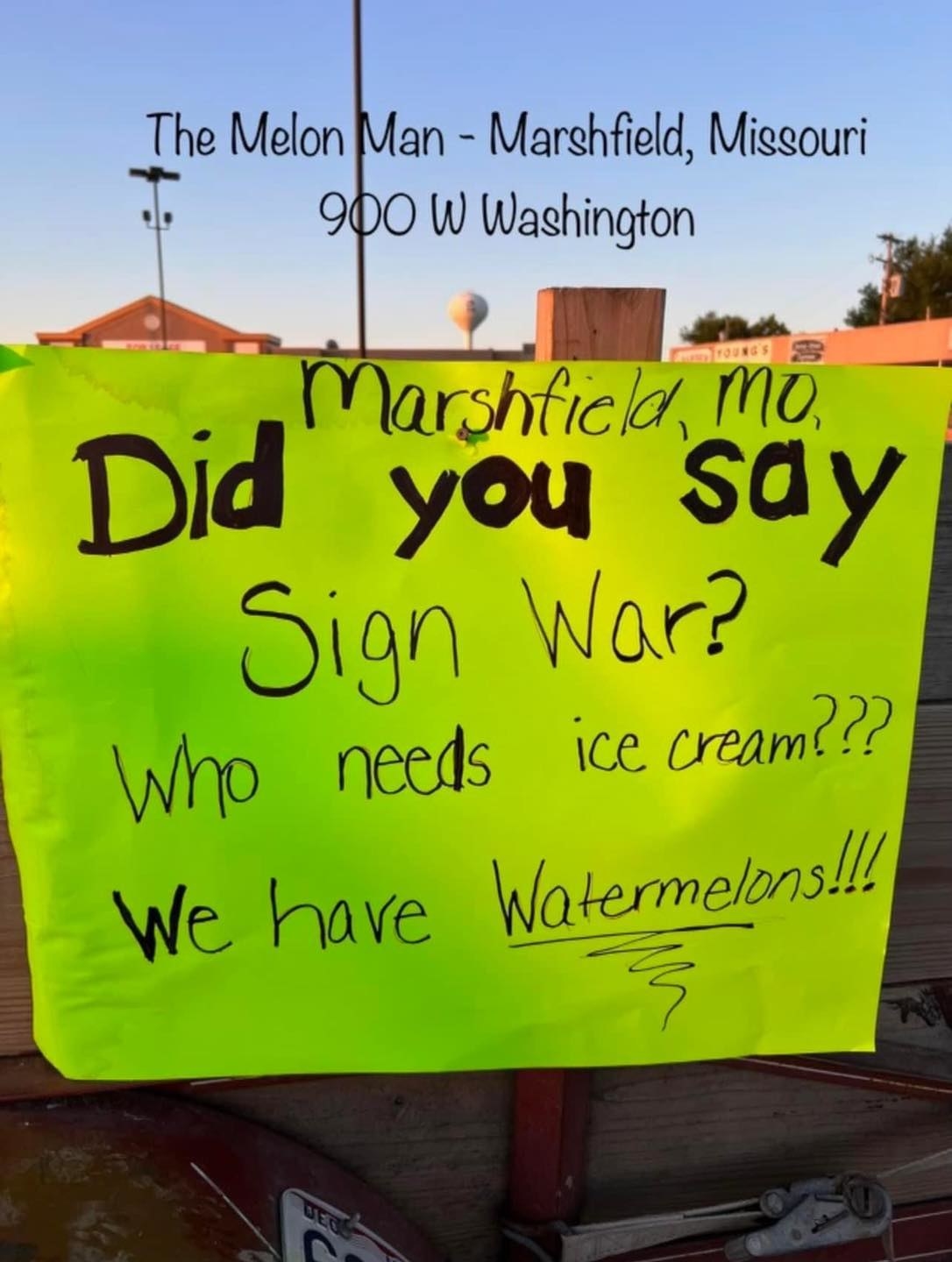 A handwritten sign says &quot;Did you say sign war? Who needs ice cream? We have watermelons&quot;
