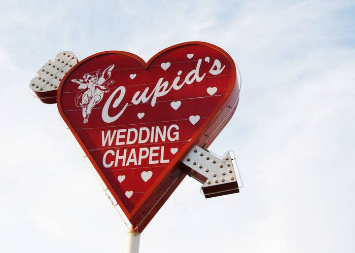 cupid&#x27;s wedding chapel sign which is a heart with an arrow going through it
