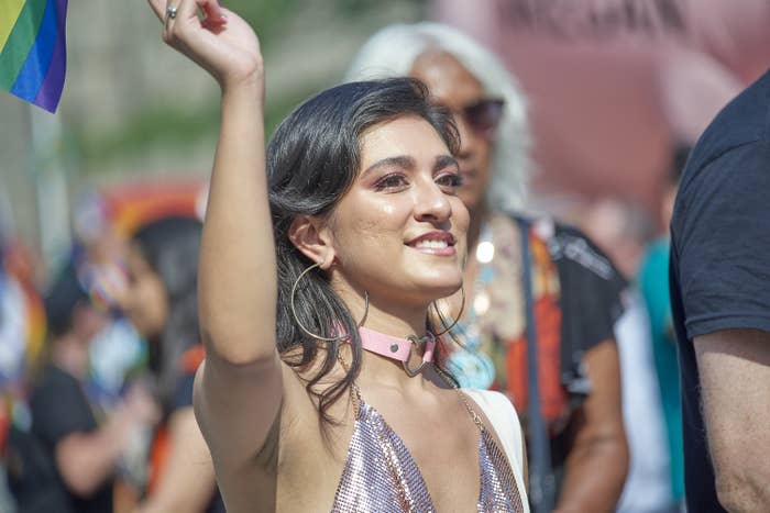 A close-up portrait of an Indian woman walking in Toronto's annual Pride parade