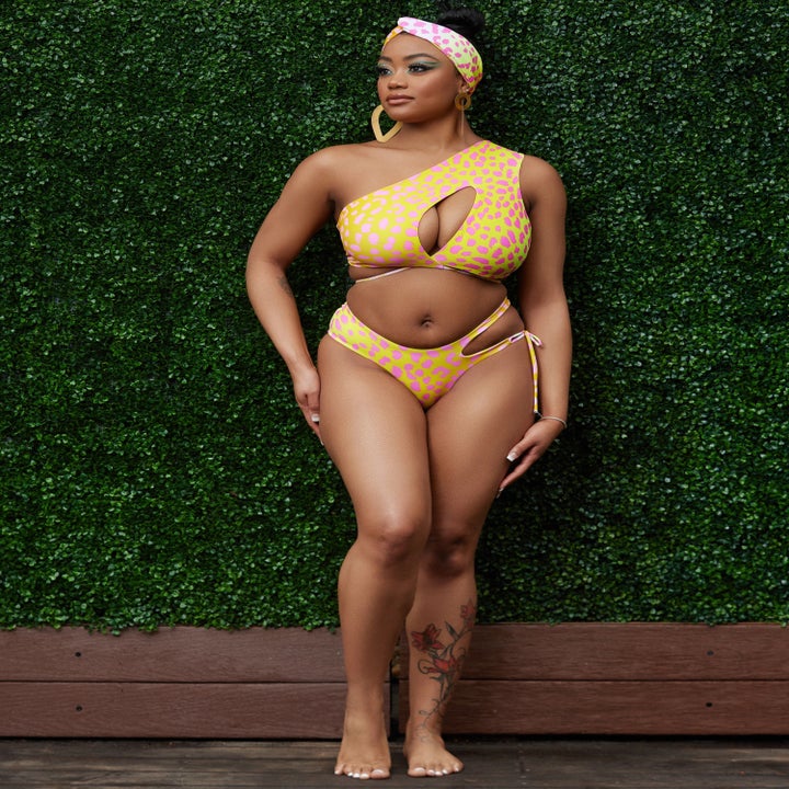 model wearing a yellow and pink leopard bikini