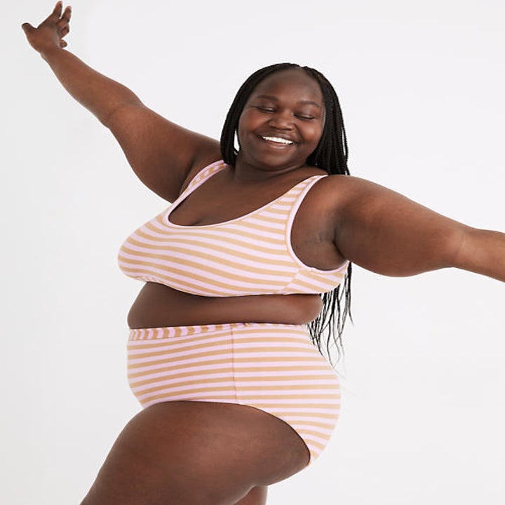 model wearing striped yellow and orange bikini