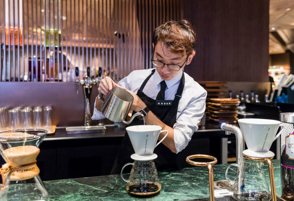 a barista making a pour-over