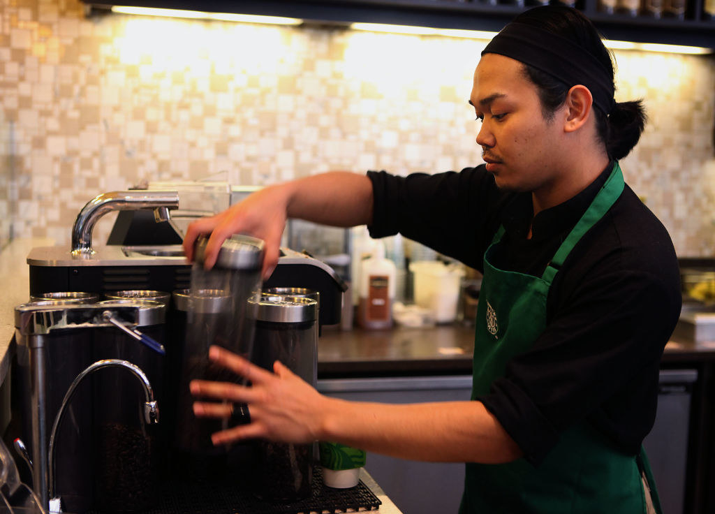 barista pulling out a traveler