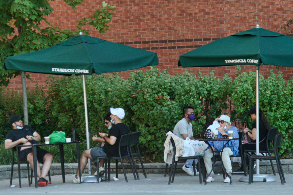 people sitting outside at Starbucks