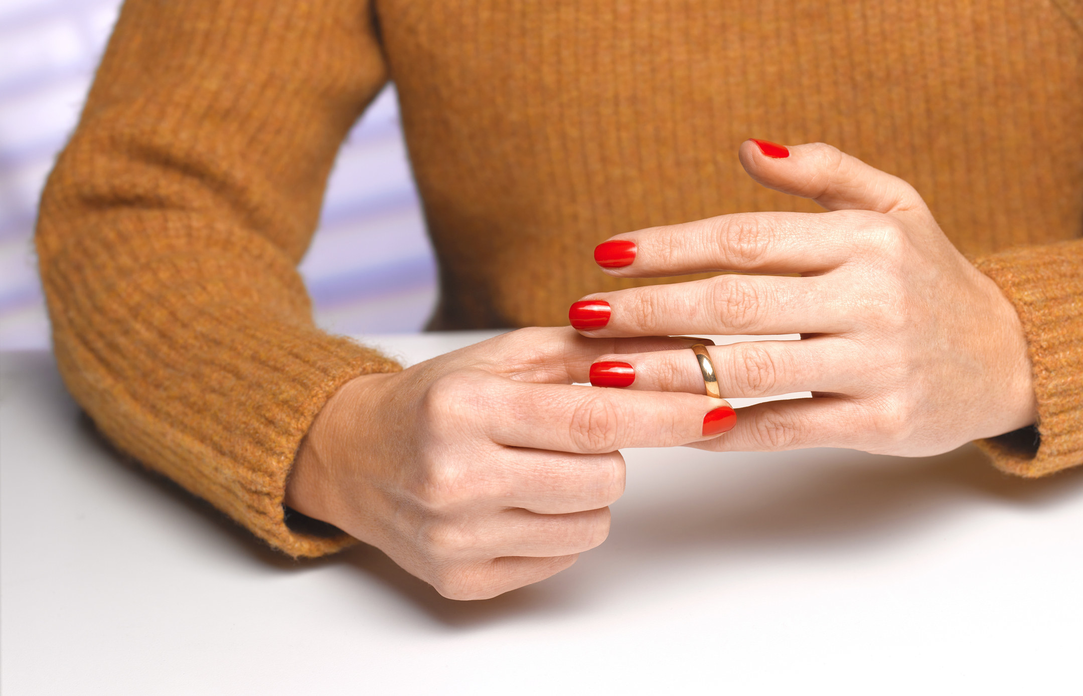 A woman removing her wedding ring