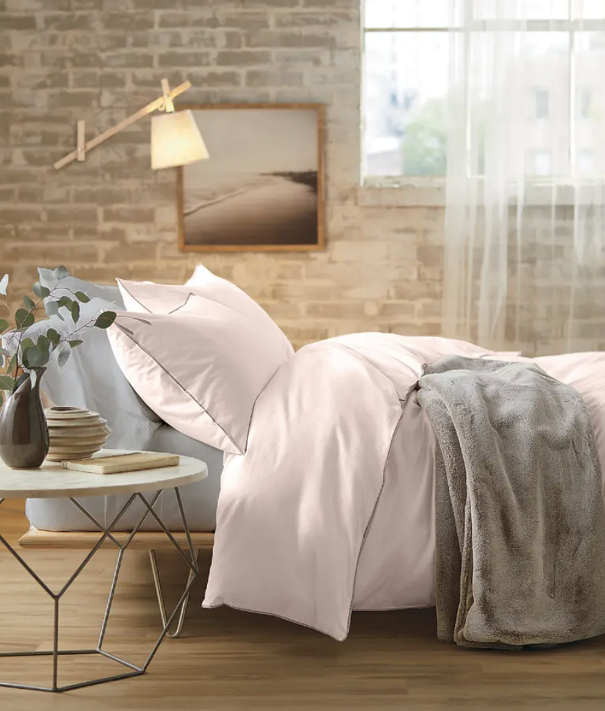 a bed made up with the duvet cover and matching shams