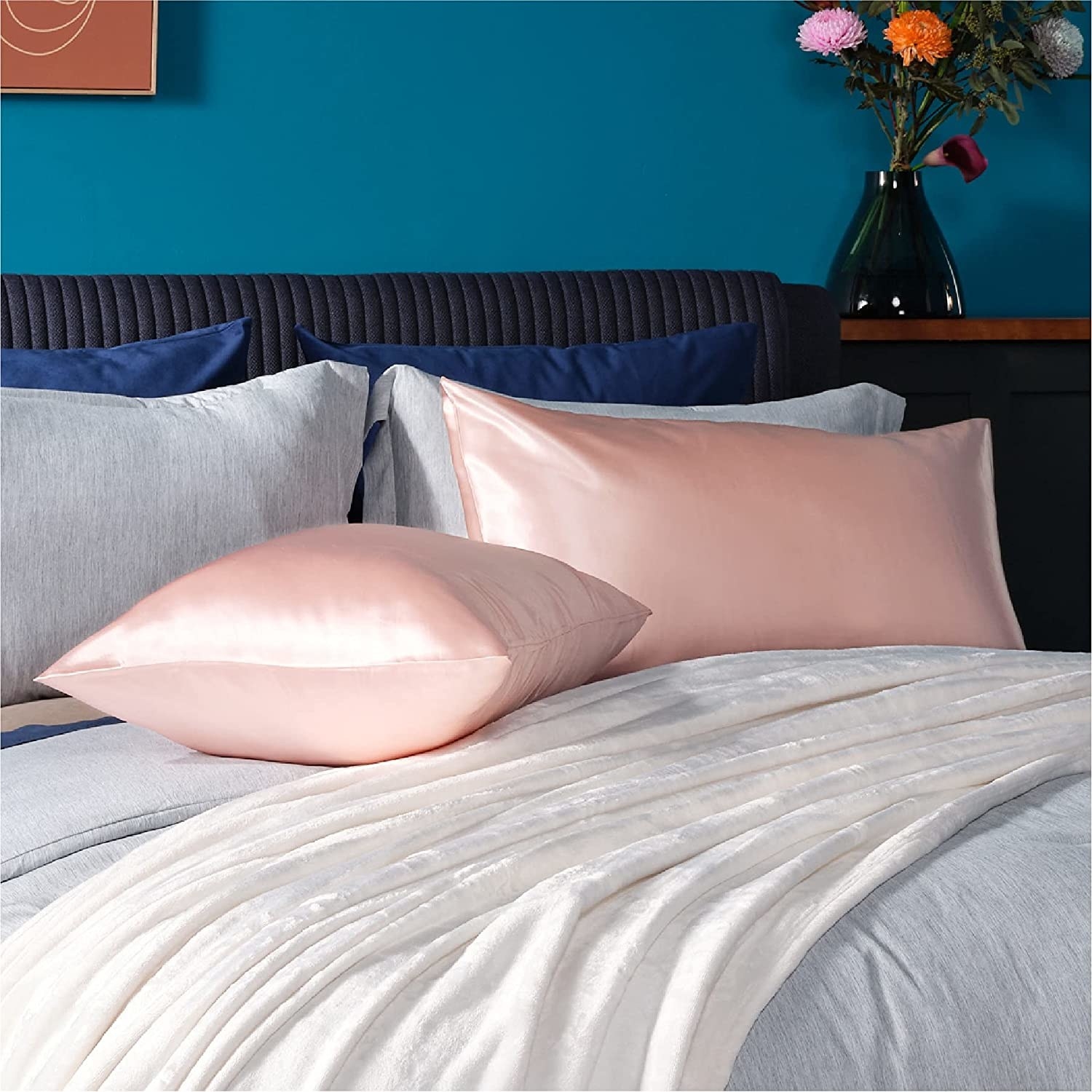 Two pillows in satin pillowcases on a bed