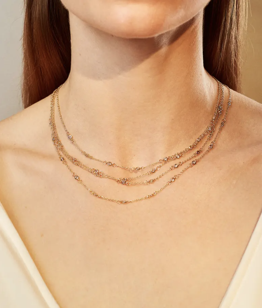 a person wearing the multi-strand chain necklace around their neck