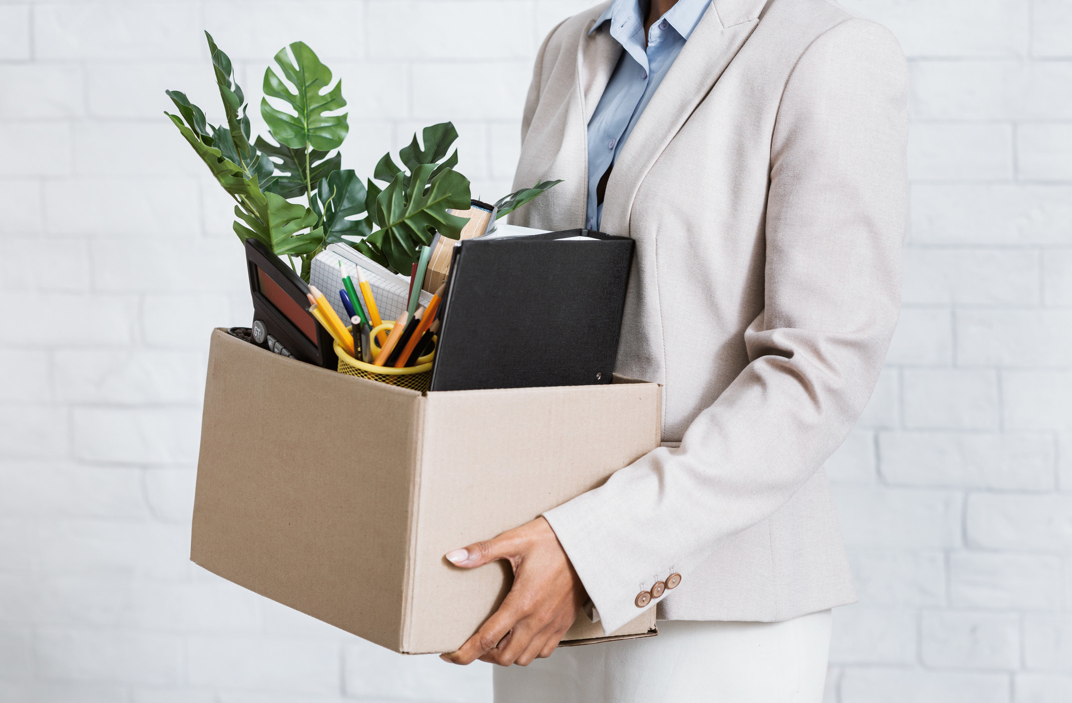 A person holding a box with their belongings