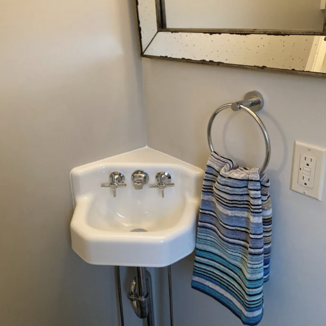 A silver towel ring with a towel hanging from it