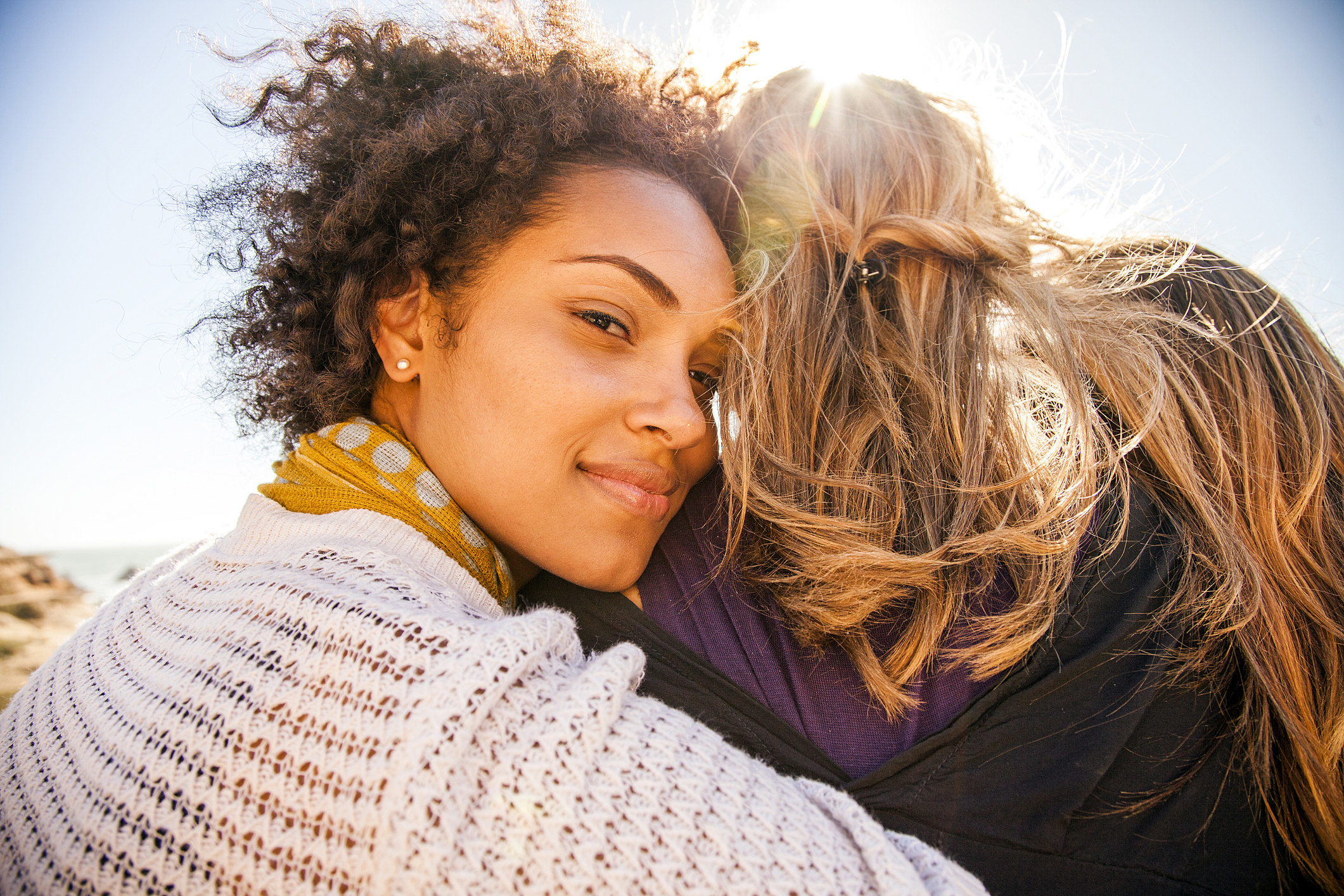 A woman embracing another woman