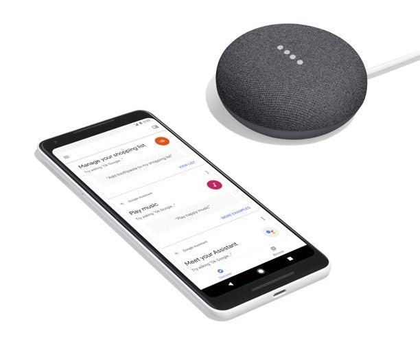 the google home next to a smart phone