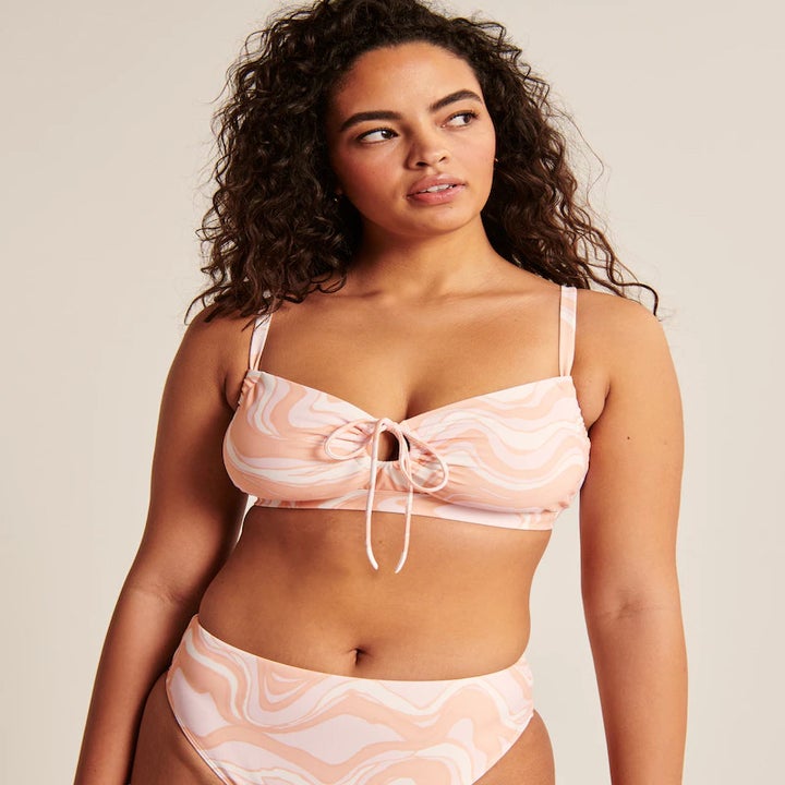 a model wearing a pink patterned bikini set