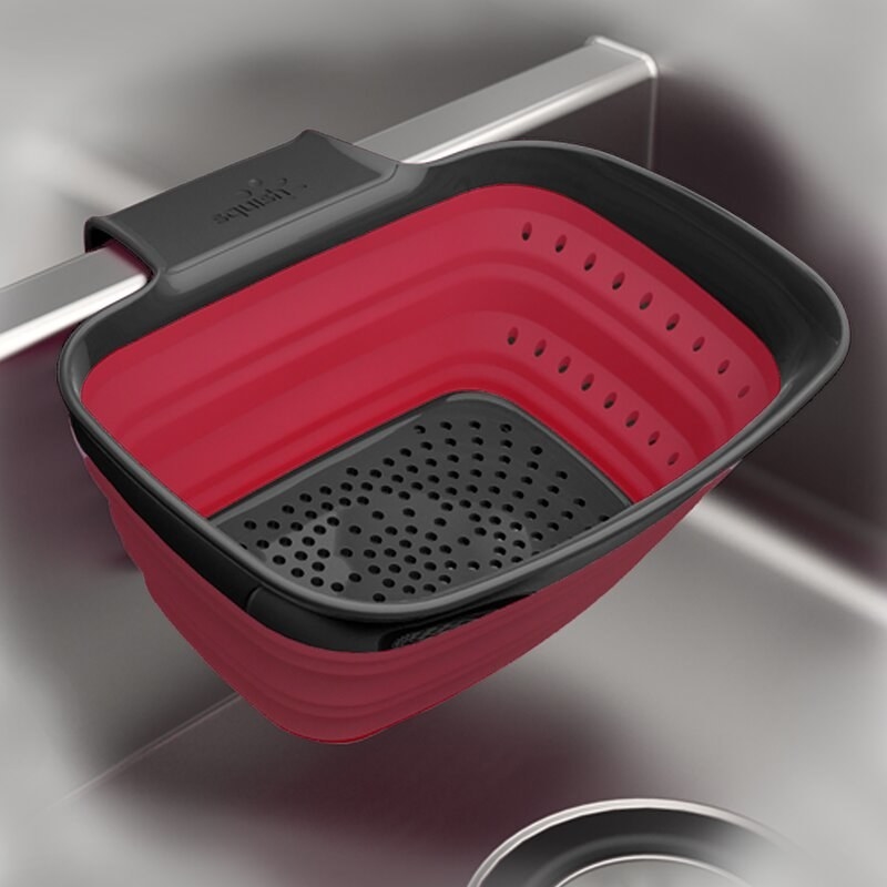 the black and white strainer in a stainless steel sink