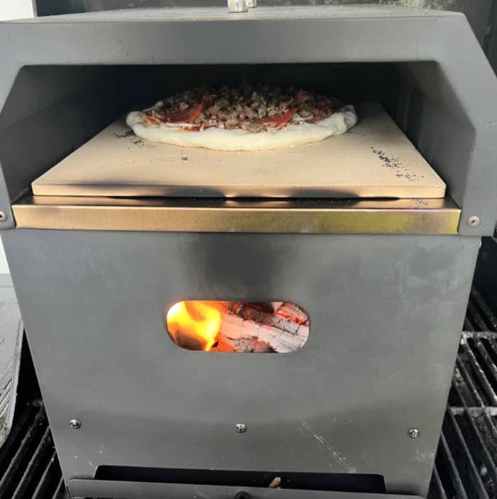 A reviewer&#x27;s pizza oven with a pizza inside
