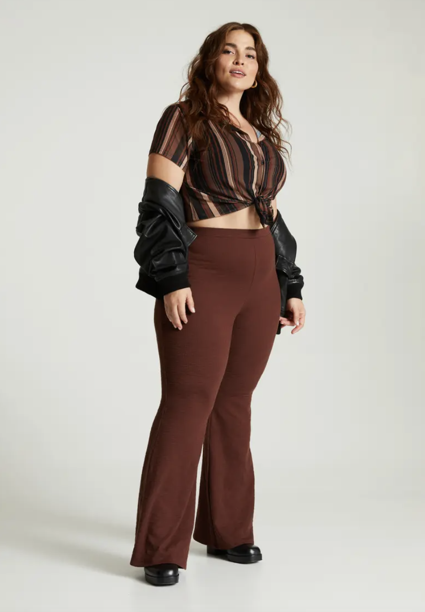 a person wearing the ribbed flare pants with a matching crop top